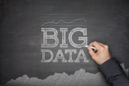 Big data concept on blackboard with handの写真素材
