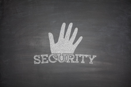 Security concept on black blackboard with handの写真素材