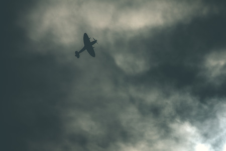 Fighter plane on cloudy skyの写真素材