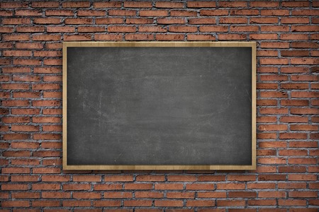 Black vintage wooden frame blank blackboard on brick wall backgroundの写真素材