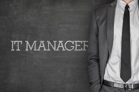 IT manager on blackboard with businessman in a suit on sideの写真素材