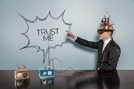 Vintage businessman concept pointing on the wall wearing futuristic helmet at officeの写真素材