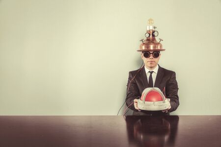 Vintage businessman sitting at office desk with alert lightの写真素材