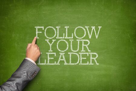 Business text on blackboard with businessman hand pointingの写真素材