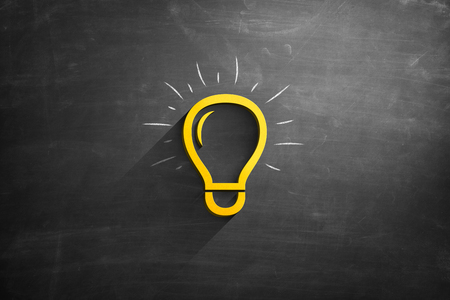 Light bulb icon on blackboardの写真素材