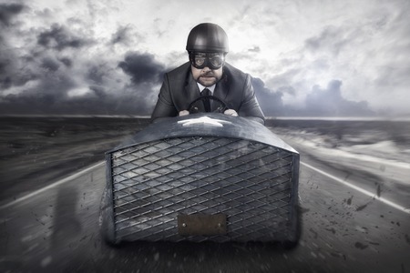 Businessman flying with a wooden toy planeの写真素材