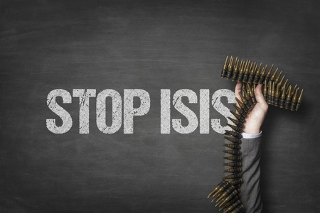 Stop isis text on blackboard with businessman hand holding ammunitionの写真素材