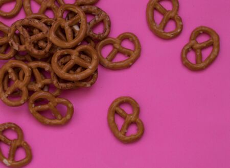 salted bretzel food pattern on a pink backgroundの写真素材