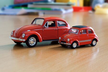 Two red toy cars on tableの写真素材