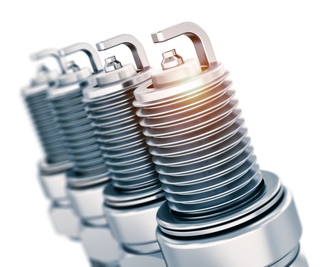 Creative car repair service and automotive transportation industry business concept  set of four metal spark plugs isolated on white backgroundの写真素材