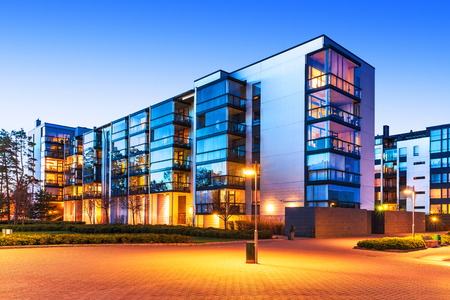 House building and city construction concept: evening outdoor urban view of modern real estate homes House building and city construction concept: evening outdoor urban view of modern real estate homes