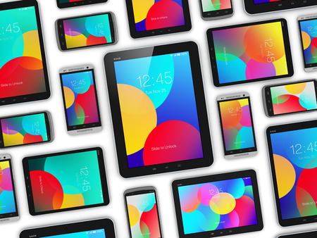 Creative abstract mobility and digital wireless communication technology business concept: group of tablet computer PC and modern black glossy touchscreen smartphones or mobile phones with color screen interface isolated on white backgroundの写真素材