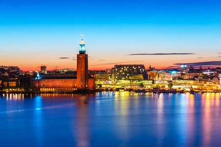 Scenic summer evening panorama of the Old Town Gamla Stan architecture pier and City Hall in Stockholm, Swedenの写真素材