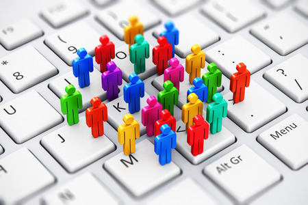 Creative abstract social media, internet communication and business marketing corporate web concept: macro view of group of 3D color people figures on white laptop or notebook computer PC keyboard with selective focus effectの写真素材