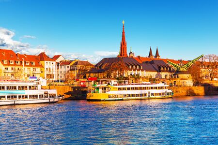 Scenic sunset evening view of old buildings at Main river pier and street architecture in the Old Town of Wurzburg, Bavaria, Germanyの写真素材