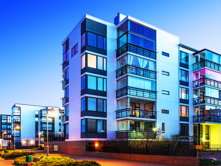 House building and city construction concept: evening outdoor urban view of modern real estate homesの写真素材