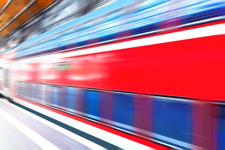 Creative abstract railroad travel and railway transportation industrial concept: modern red high speed electric passenger commuter double deck train at station platform with motion blur effectの写真素材