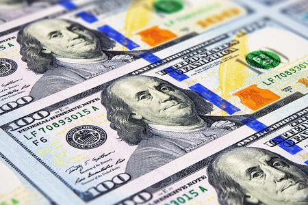 Creative abstract business, financial success and making money concept: macro view of group of new 100 US dollar 2013 edition banknotes or bills with selective focus effectの写真素材