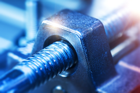 Creative abstract heavy industry, metal processing and steel manufacturing industrial business concept: macro view of industrial tool part with screw carving or thread with selective focus effectの写真素材