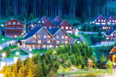Scenic summer view of winter mountain ski resort with house cottages with forest and skiing slope in Bukovel, Ukraineの写真素材
