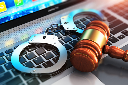 Creative abstract cyber crime, online piracy and internet web hacking concept: 3D render illustration of the macro view of metal handcuffs and wooden judge mallet, gavel or hammer on laptop notebook computer keyboard with selective focus effectの写真素材