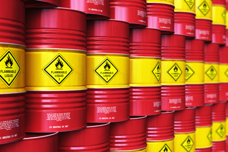 Creative abstract oil and gas industry manufacturing and trading business concept: 3D render illustration of the group of the industrial storage warehouse with a stacked rows of red metal oil drums or petroleum barrels with selective focus effectの写真素材