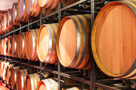 Old cellar winery interior with big wooden wine barrelsの写真素材