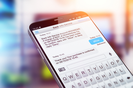 Creative abstract wireless communication computer technology business network concept: 3D render illustration of the macro view of modern black glossy touchscreen smartphone or mobile phone with SMS text message app on screen in the office with selective focus bokeh blur effectの写真素材