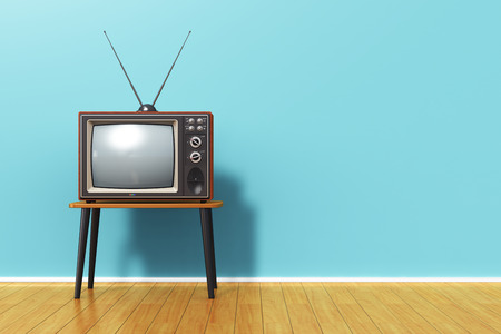 Creative abstract 3D render illustration of the old retro TV television set with antenna on table against blue vintage wall background and wooden plank floor in the roomの写真素材