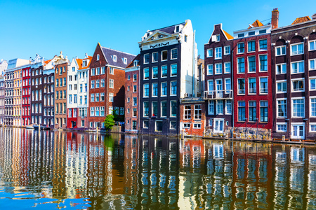 Scenic summer view of iconic ancient medieval buildings and canal pier architecture in the Old Town of Amsterdam, Netherlandsの写真素材