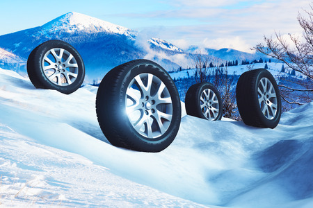 Creative abstract auto industry, service and maintenance repair business technology automotive concept: 3D render illustration of the set of SUV car wheels with offroad winter tyres or tires on snow in nature outdoor landscapeの写真素材