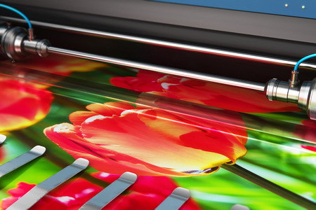 3D render illustration of printing photo banner on large format color plotter in typography or print house printshopの写真素材