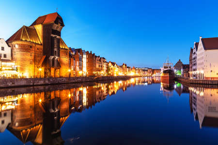 Scenic night view of the Old Town pier architecture of Gdansk, Poland at the Motlawa River harbor...