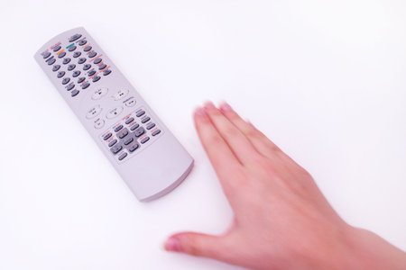 Hand with television remoteの写真素材