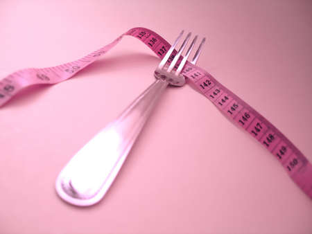 Fork with measuring tape. For dieting purposes.の写真素材