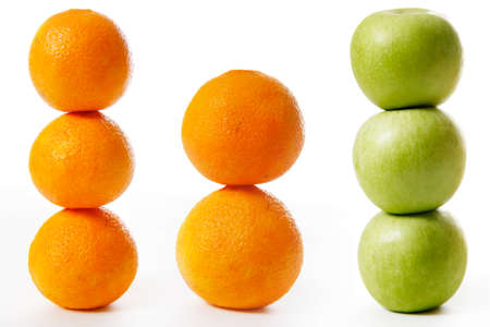 Stack of apples and oranges isolated on white backgroundの写真素材