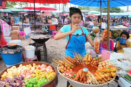 Meat balls and sausages on sticks in a bowl with sauce on Phuket market, Thailandのeditorial素材