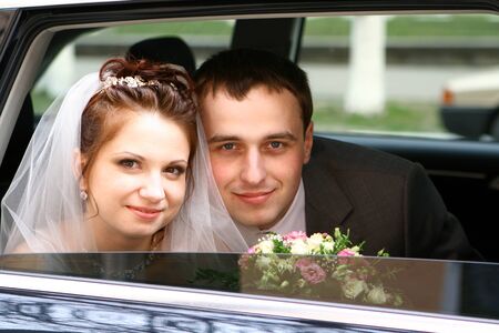 Bride and groom in carの写真素材