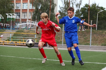 BELGOROD, RUSSIA - AUGUST 20  Unidentified boys plays football on August, 20 2010 in Belgorod, Russia  The final of Chernozemje superiority, Football kinder team of 1996 year of birth  のeditorial素材