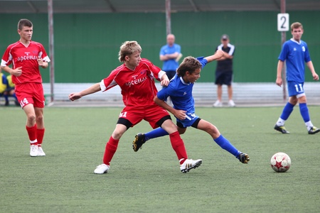 BELGOROD, RUSSIA - AUGUST 20  Unidentified boys plays football on August, 20 2010 in Belgorod, Russia  The final of Chernozemje superiority, Football kinder team of 1996 year of birth  のeditorial素材