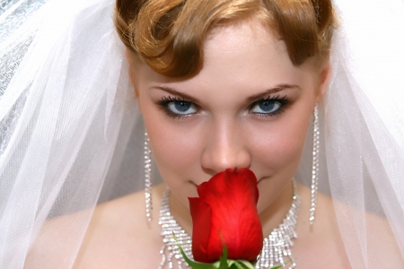 Beautiful bride with red roseの写真素材