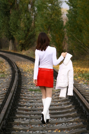 Young woman in white leaving on the railwayの写真素材
