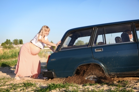 Pregnant woman pushing carの写真素材