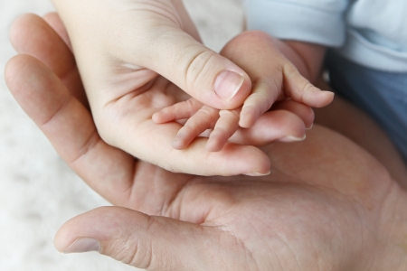 Hands of mother, father and babyの写真素材