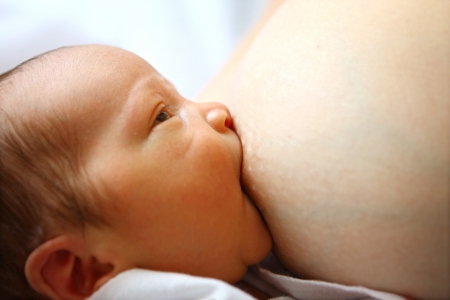 Baby sucking mother s breastの写真素材