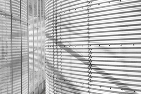 Metal wall of tank inside industrial buildingの写真素材