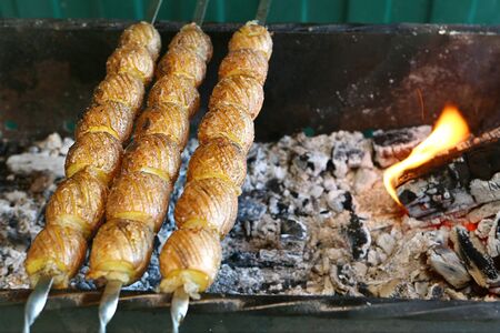 Salted and oiled potato prepared on charcoalの写真素材
