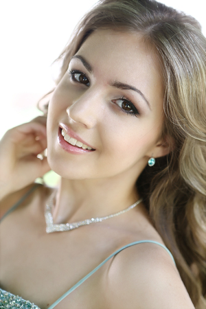 Pretty woman with long brown hair in green dressの写真素材