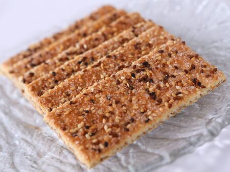 Sesame cakes with cocoa and sugar on glass plateの写真素材