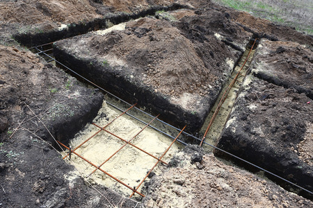 Technology of digging tranches under the pile and tape base (fundament) on building of the house at the beginning of a construction seasonの写真素材